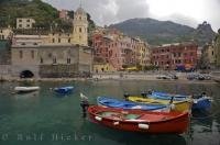 Quaint fishing boats line the waterfront in the pretty village of Vernazza, Liquria, Italy.