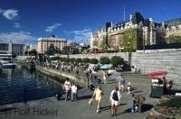 A popular summer time activity is a walk along the waterfront in the pretty city of Victoria in BC with the Fairmont Empress Hotel in the background.