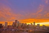 The vivid colors of the sunset add to the beauty of the skyline in the City of Calgary in Alberta, Canada. Over the Bow River, the Centre Street Bridge leads into the city of Calgary.