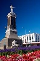 With a bed of flowers at its base, the Oamaru War Memorial stands literally in the middle of the road in downtown Oamaru, South Island, New Zealand.