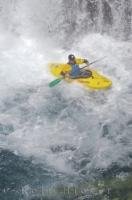 A kayaker sitting upright after descending the Sauth deth Pish waterfall while taking part in the water sport of waterfall running.