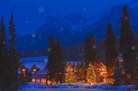 The sight of warm cozy lights shining brightly from the Post Hotel and surrounding buildings in Lake Louise, Alberta during a winter night of snow fall is an inviting scene and makes one think of a roaring open place and hot chocolate.