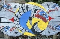 Native art on wooden circles created by Canadian First Nations is a brilliant display of colors with stories relating to a variety of symbolic animals.
