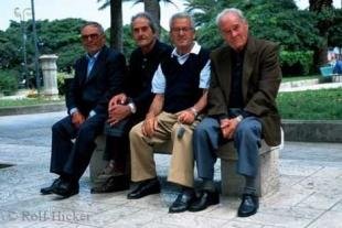 photo of Men Sitting On Bench