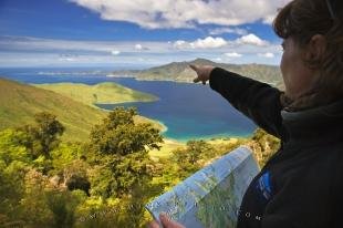 photo of Woman Pointing Direction Scenic Coastal Bay